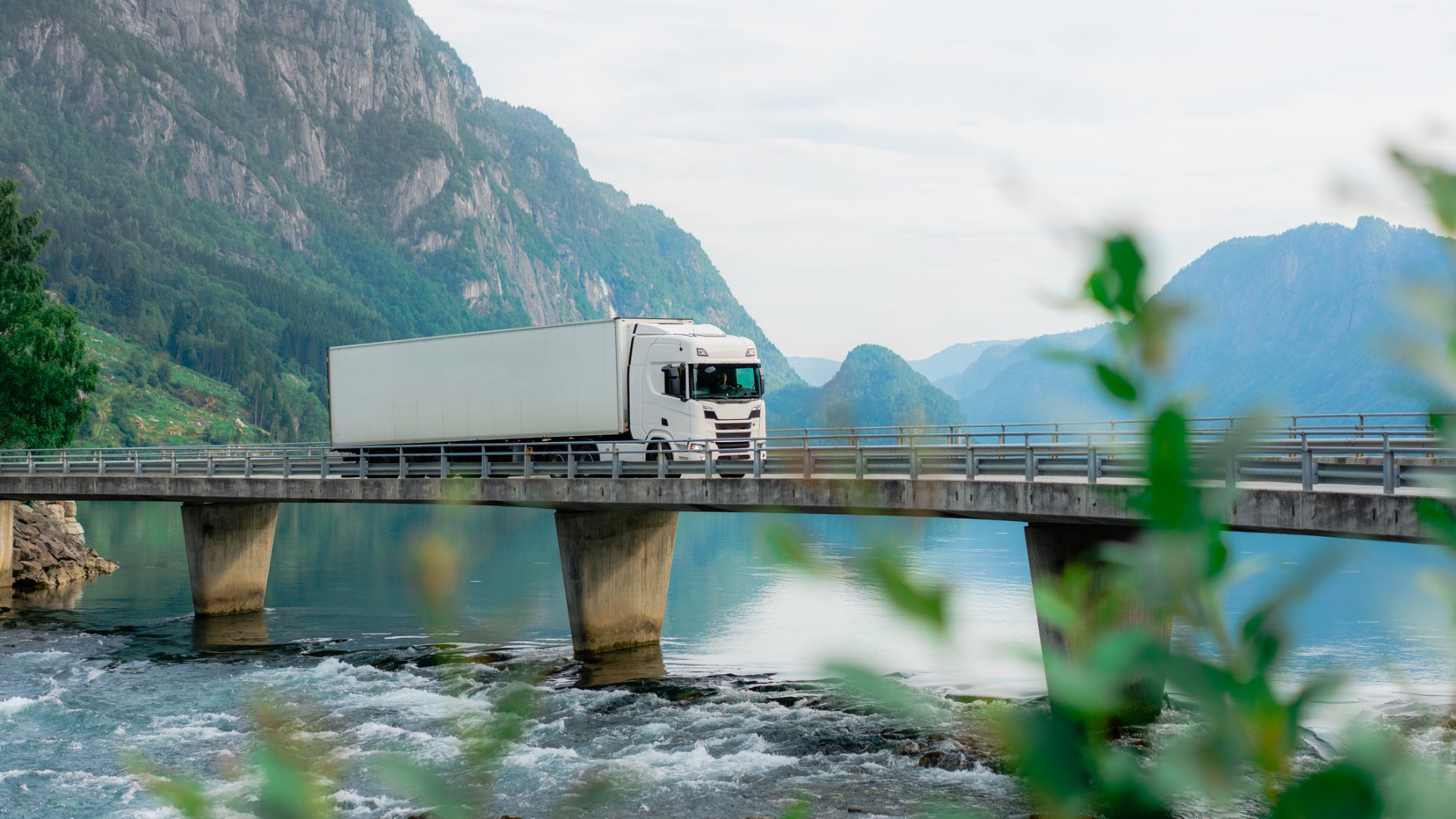 Scenic view of  truck on the bridge across the river  falls into fjord in Norway